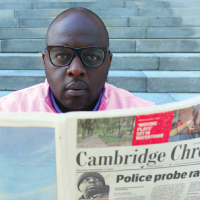 Tony Clark reads Cambridge Chronicle newspaper